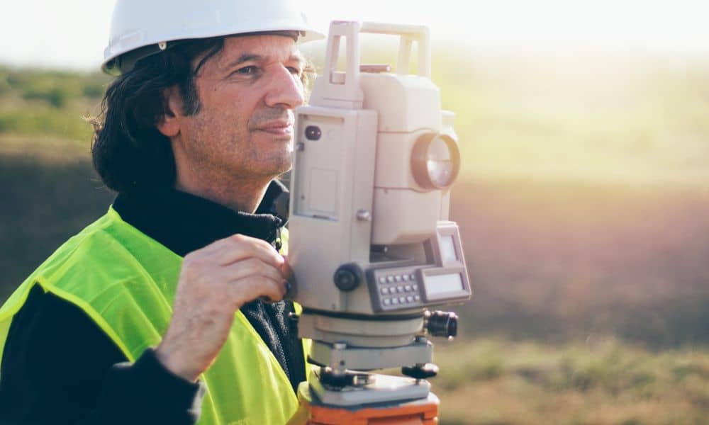 licensed and surveyor massachusetts property boundary - ALTA SURVEY Massachusetts A licensed land surveyor in Massachusetts using a total station to measure property boundaries before a land purchase.