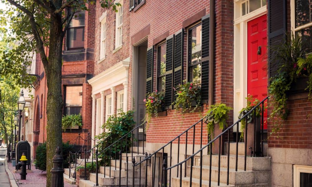 Row of historic brick homes in Boston where narrow property lines may require boundary surveys