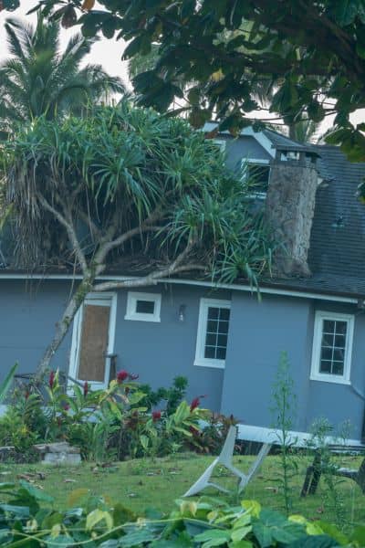Damaged home and leaning structure after a severe storm showing why a Flood Elevation Survey may be needed

