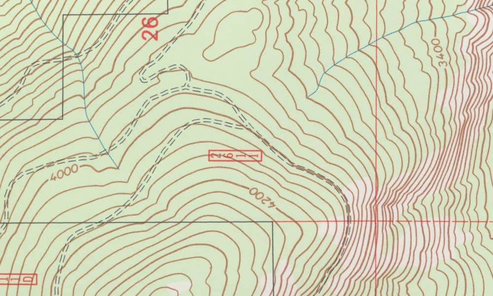 Topographic survey map with contour lines showing elevation changes and potential flood vulnerability across sloped terrain