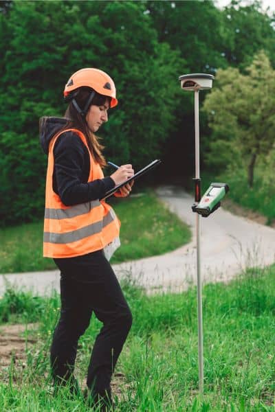 Surveyor marking accurate boundaries during a property line survey