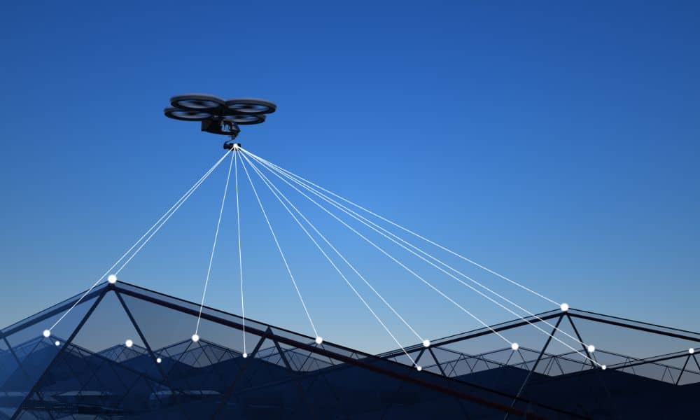 Drone collecting LiDAR mapping data by scanning the ground with laser beams to create accurate site models for modern projects