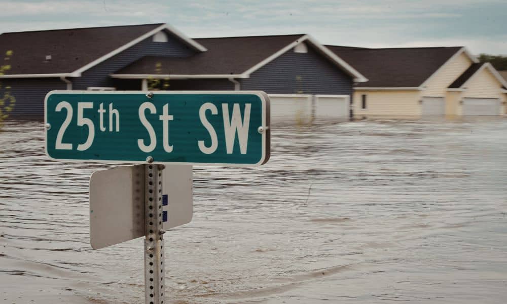 Coastal flooding storm warning - ALTA SURVEY Massachusetts Flooded coastal street during a storm, showing rising water levels and the importance of an elevation certificate for flood risk assessment