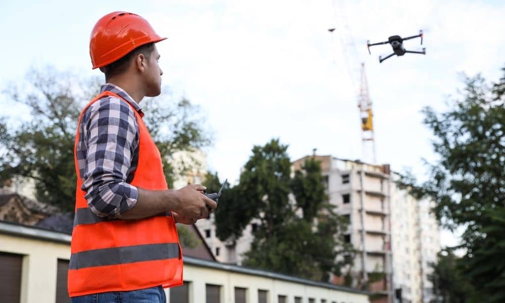 Drone land surveying being conducted by a professional surveyor at an active urban construction site