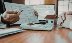 Commercial property closing document review - ALTA SURVEY Massachusetts Commercial buyers reviewing an alta survey during a property closing meeting