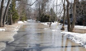 Winter street flooding affecting one block, showing how lidar mapping helps identify hidden low points and drainage paths
