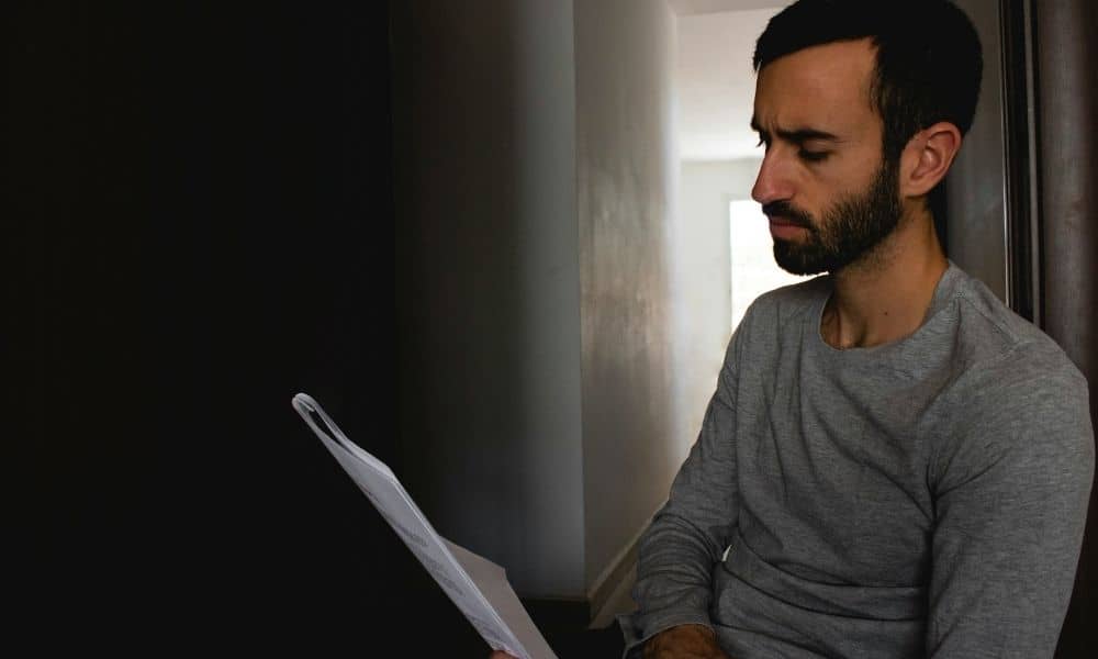 Homeowner reviewing property documents before hiring a professional land surveyor